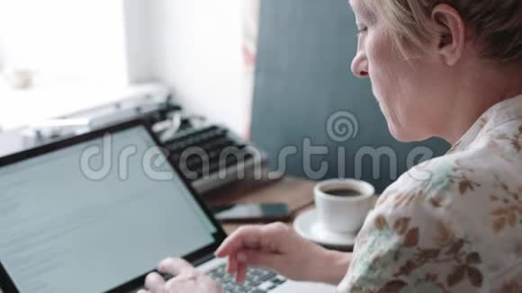 女性使用笔记本电脑的背面视图视频的预览图
