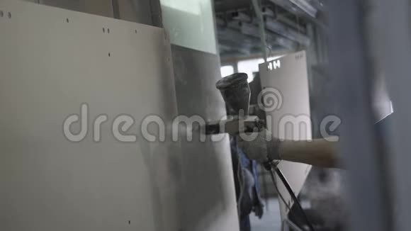 工厂工人在装配线上喷漆家具部件视频的预览图