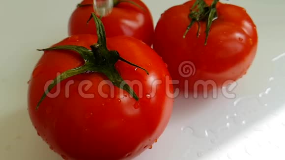 西红柿成熟健康液体明亮纯净水浇维生素慢动拍摄湿落视频的预览图