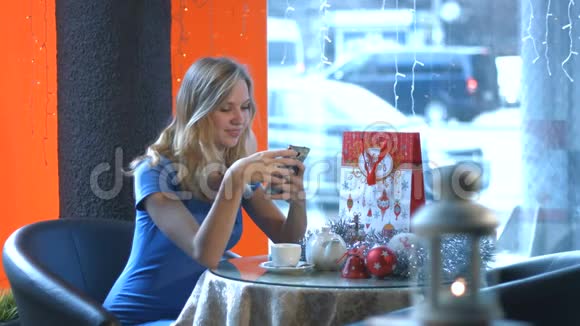 咖啡馆里有智能手机的女孩视频的预览图