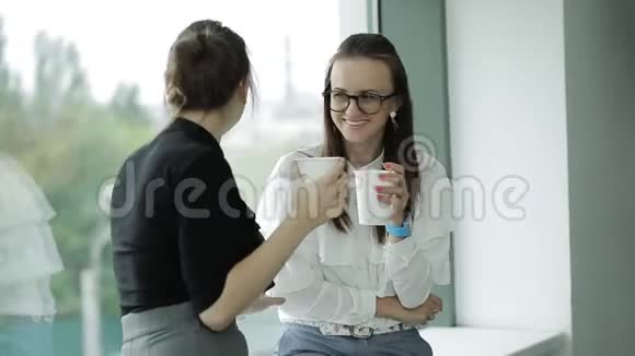 两个女商人在办公室休息时喝咖啡视频的预览图