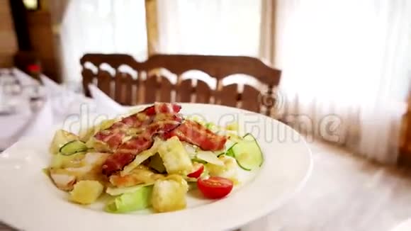 服务员在餐厅里端来一盘带有沙拉的菜盘子上铺着白色桌布餐具和盘子视频的预览图
