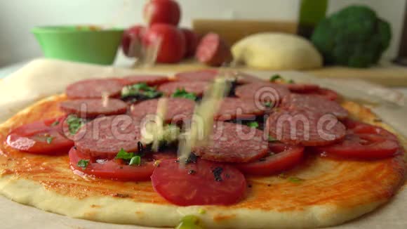 女人在自制比萨饼上倒奶酪烹饪部分套餐4K近距离射击视频的预览图