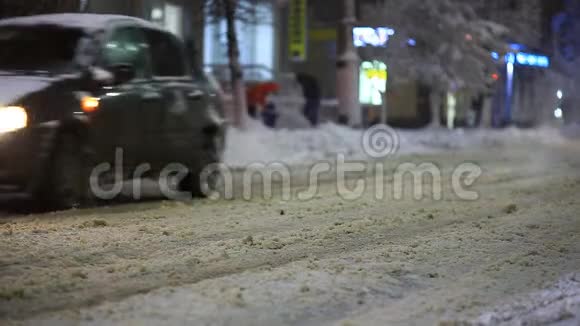 汽车在冬天在城市降雪冬天的道路视频的预览图