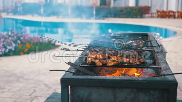 鸡肉烧烤是在一个大烤架上由厨师在酒店的游泳池与蓝色的水埃及视频的预览图