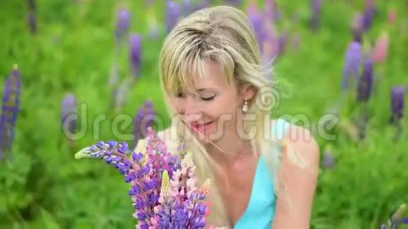 在田野里的女人手里拿着一束鲜花视频的预览图