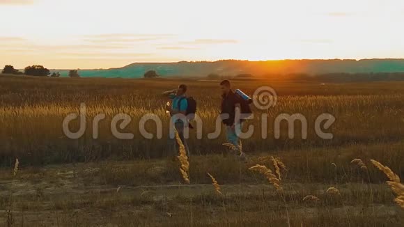 两个徒步旅行者带着背包自然一个高峰云天背景慢动作视频旅行成功的年轻人视频的预览图