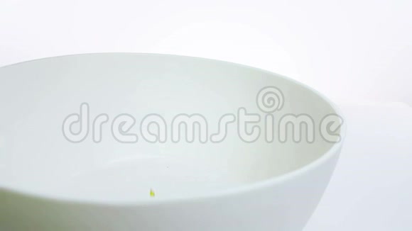 谷物玉米片落在碗里在白色背景下缓慢运动饮食健康食品的概念视频的预览图