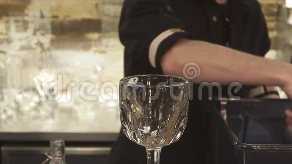 酒保拿着冰块鸡尾酒杯酒保准备酒精鸡尾酒快关门视频的预览图