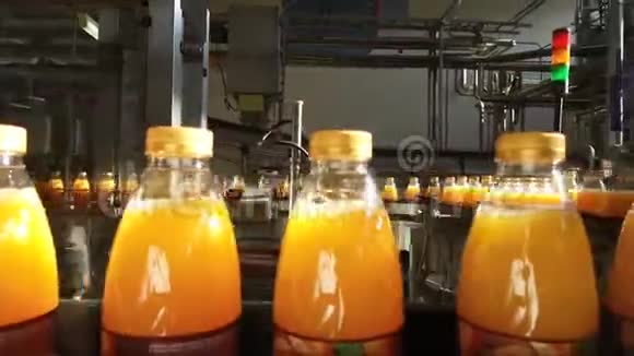 装满果汁的瓶子正沿着传送带移动视频的预览图