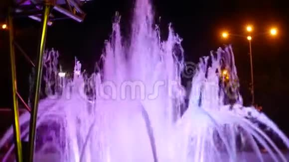 一个有彩色灯光的喷泉在晚上特写4k视频的预览图