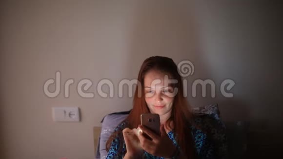 生活方式的女人在卧室里手机躺在床上视频的预览图