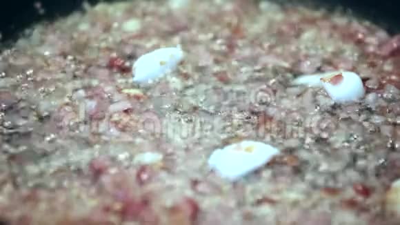 做晚餐切洋葱在锅上烤肉加入脂肪油泡视频的预览图