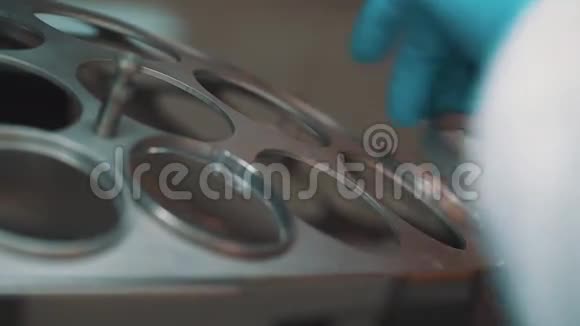 科学家用橡胶手套将放大镜放入旋转装置的孔中视频的预览图