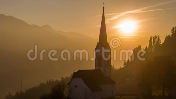 日落教堂橙色阿尔卑斯山瑞士空中4k视频的预览图