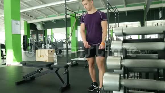 强壮的运动员带着沉重的哑铃在健身房积极锻炼健身视频的预览图