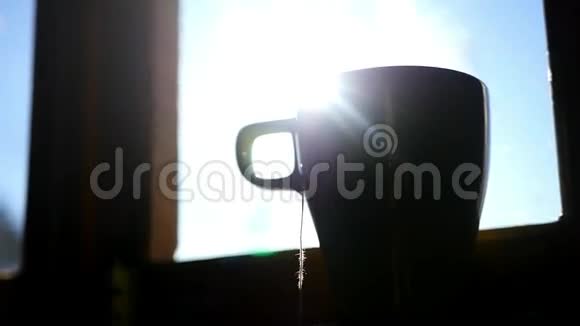 一杯茶一袋茶站在靠近窗户的窗台上阳光明媚美丽视频的预览图