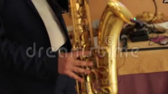 穿着燕尾服的萨克斯演奏家用萨克斯演奏音乐音乐家在音乐会上演奏萨克斯管演奏爵士夜视频的预览图