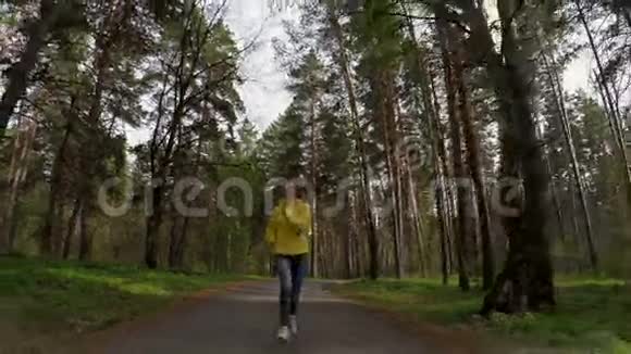 女人在森林路上奔跑慢动作视频的预览图