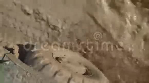 穿过装甲运兵车上的泥浆泥土在车轮下飞舞视频的预览图