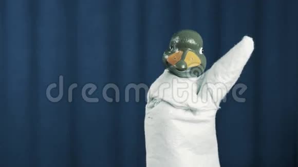 鸭手木偶交叉上升和展开手臂在蓝色背景视频的预览图