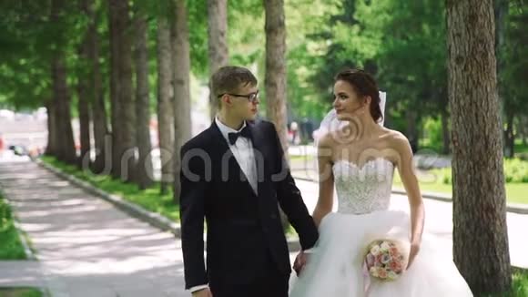 婚礼情侣在城市公园散步视频的预览图