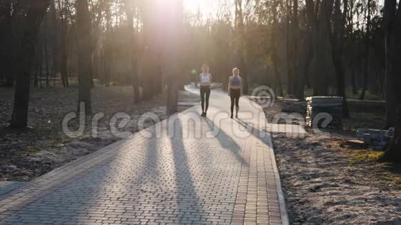 两名运动女子在公园的混凝土跑道上缓慢地跑着健康健身理念视频的预览图