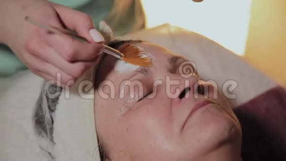 一位专业的美容师给一位老年妇女戴面膜宇宙学创新视频的预览图