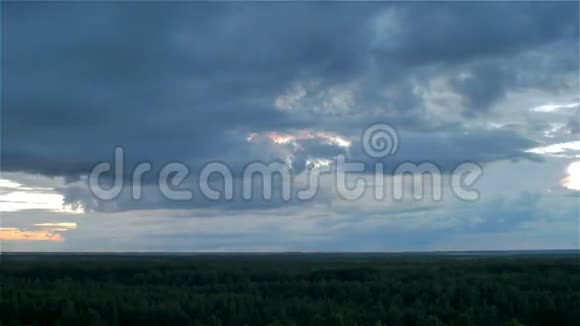 在绿色的夏日森林上空暴风雨的云团在空中降落视频的预览图