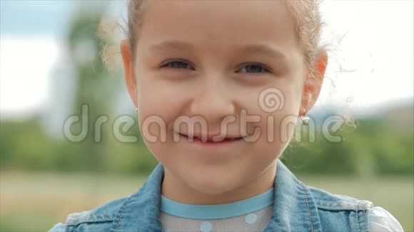 特写肖像可爱快乐的白种人小女孩微笑着看着镜头享受着温暖的暑假晴天视频的预览图