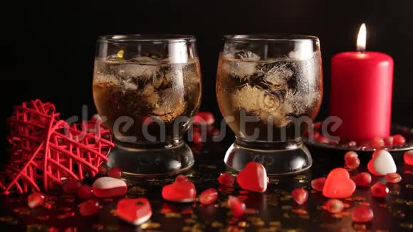 黑色背景下的浪漫静物很长一段时间蜡烛燃烧的火焰用酒精饮料反射眼镜视频的预览图