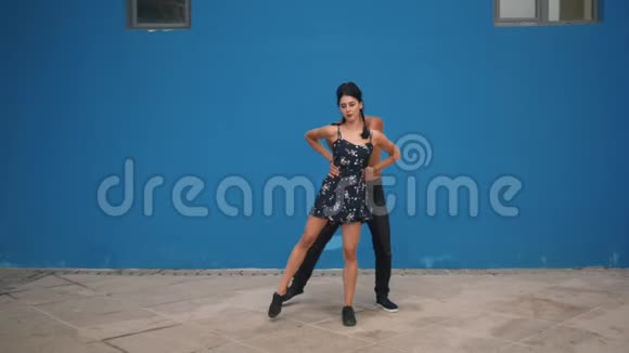 舞蹈伙伴展示感官舞蹈模式与杂技在蓝色背景下缓慢运动户外舞蹈视频的预览图