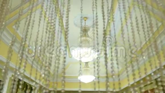 天花板上老式漂亮的水晶吊灯大型仪式大厅视频的预览图