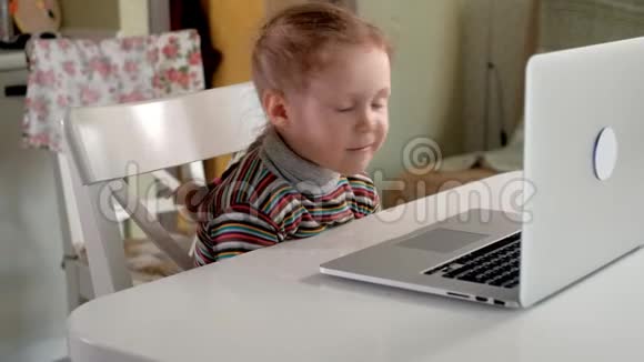 小女孩用笔记本电脑通过Skype和妈妈聊天视频的预览图