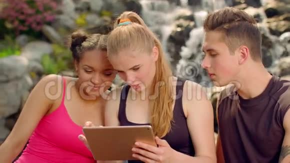 年轻人平板电脑朋友平板电脑多种族朋友在户外视频的预览图
