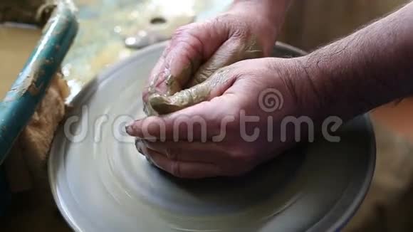 高级陶工在艺术工作坊向孩子们展示他的陶艺技巧视频的预览图