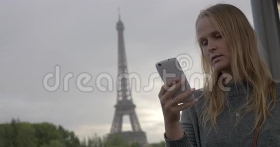使用手机拍摄埃菲尔铁塔的女人视频的预览图