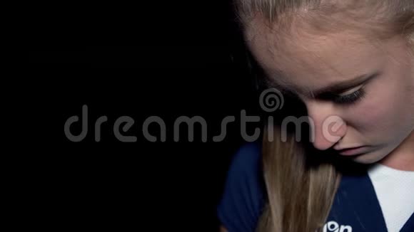 一位蓝眼睛黑背景的年轻女子的肖像4k视频的预览图