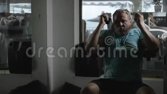成熟男人在健身房用仰卧起坐机视频的预览图