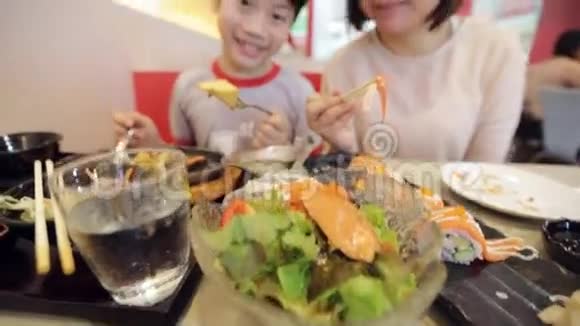 快乐的亚洲家庭在餐厅吃寿司面带笑容视频的预览图