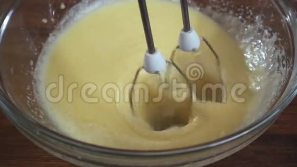 电动搅拌机特写镜头用糖搅拌蛋慢动作视频的预览图
