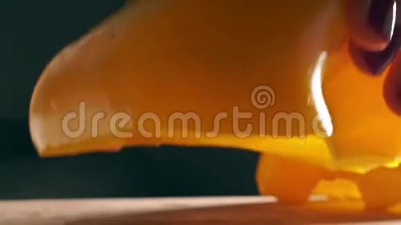 女孩用红色指甲油切黄铃椒宏观镜头视频的预览图