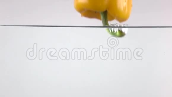 黄铃椒在水中下落的超慢动作视频视频的预览图