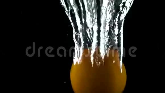 橙色在黑暗的背景下落在水中超级慢动作镜头视频的预览图