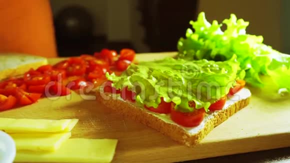 夹着奶酪片和面包的三明治视频的预览图