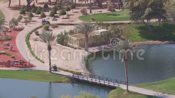 绿色高尔夫球场景观树木鸟瞰阿联酋迪拜视频的预览图