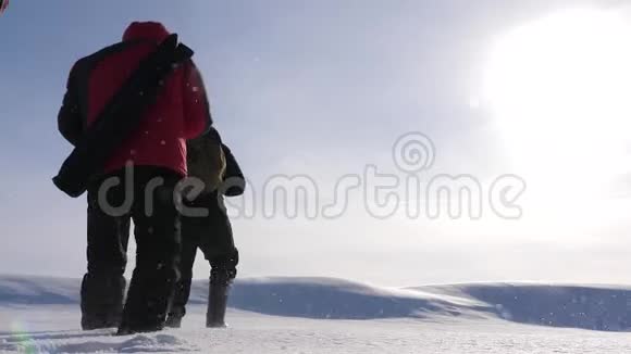 三个高山旅游者在雪域的沙漠里互相追逐团队合作和胜利商务人员团队视频的预览图