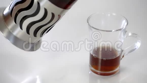 法国出版社用茶茶倒在透明杯里在白色背景下视频的预览图