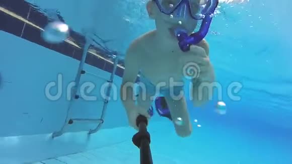带口罩的小男孩和游泳池内的浮潜视频的预览图
