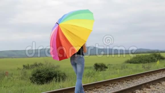 带着雨伞在铁路上跳跃的少女视频的预览图